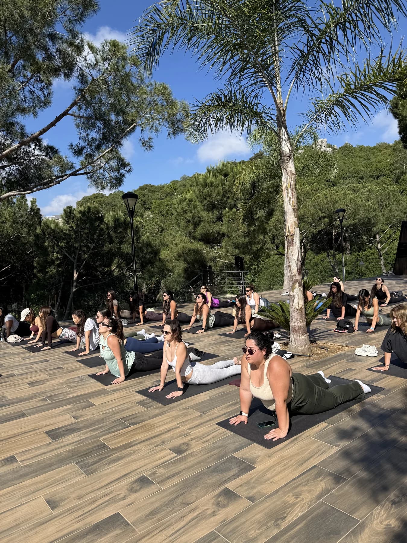 SheFlows yoga class practicing outdoors beside the pool in the Lebanese mountains.