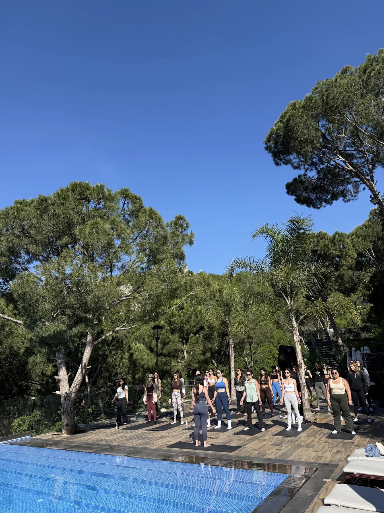 SheFlows retreat participants moving together beside the pool in the Lebanese mountains.